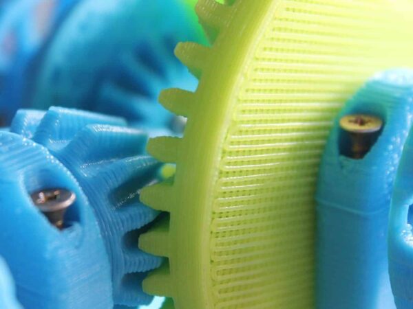 Close-up of blue and yellow 3D-printed plastic gears