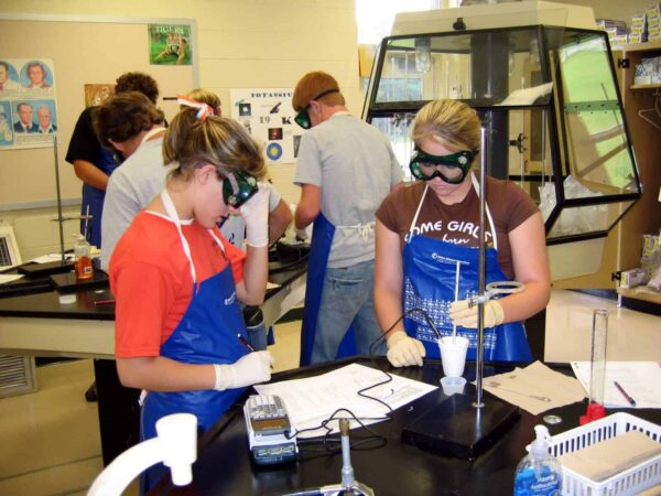 Students working at a busy school lab bench