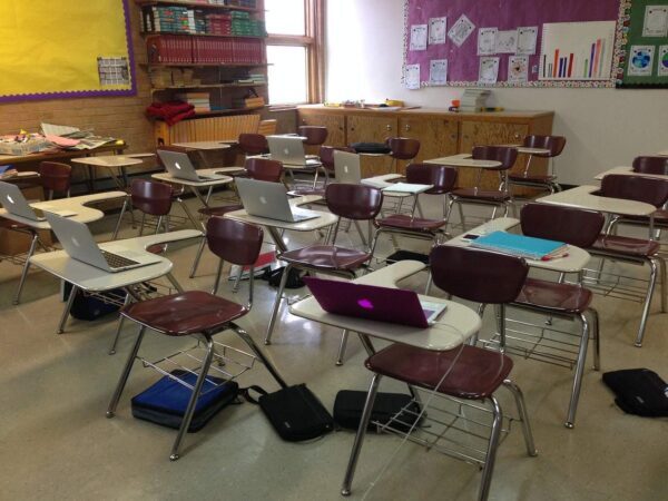 Classroom with chairs, desks and backpacks