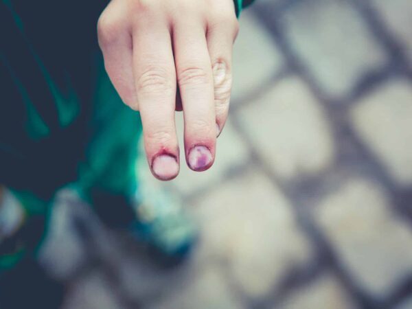 Finger pressing on a touchscreen with a blurred pattern