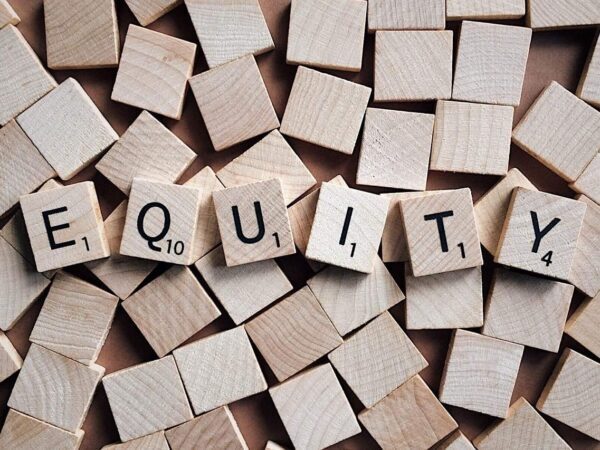 Letter tiles spelling equity | Science Safety Wooden letter tiles spelling EQUITY among blank tiles