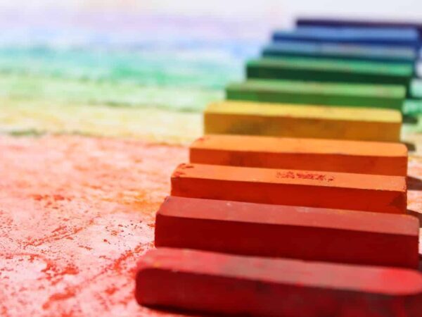 Row of coloured chalk sticks forming a rainbow