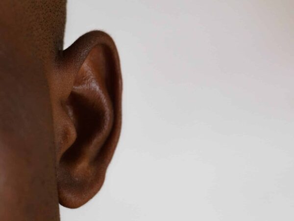 Close-up of a human ear against a white background