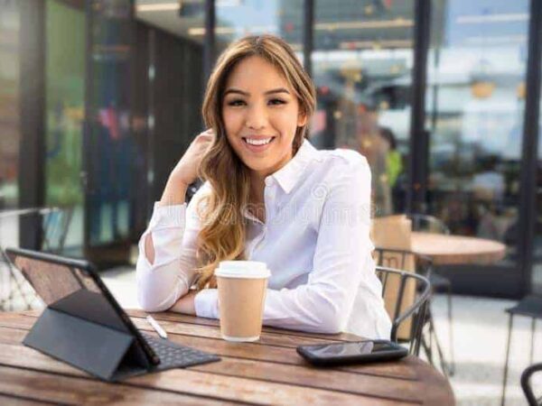 independent-multiethnic-female-entrepreneur-web-business-owner-young-self-employed-professional-working-laptop-coffee-sh-156073167 | Science Safety Smiling woman at a cafe table with a tablet