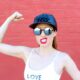 woman in white tank top wearing black sunglasses and blue and white fitted cap