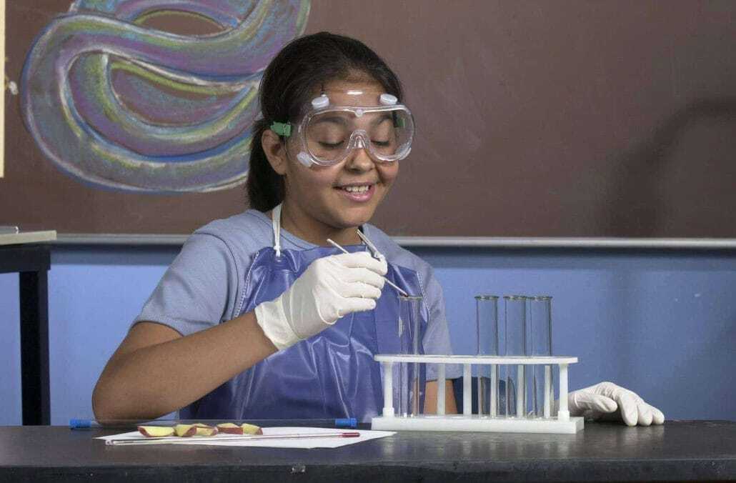 Student working with test tubes | Science Safety | Science Safety Student in safety goggles and gloves working with test tubes at a lab bench