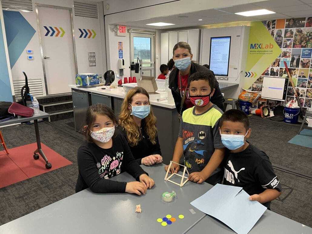 Mobile STEM lab | Science Safety | Science Safety Children in face masks working on a building activity with a teacher in a mobile STEM lab