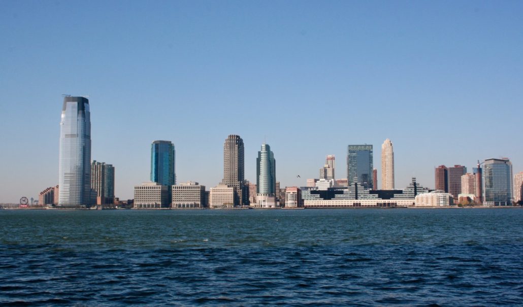 city skyline across body of water during daytime