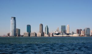 Photo by Tomas Martinez | Science Safety city skyline across body of water during daytime